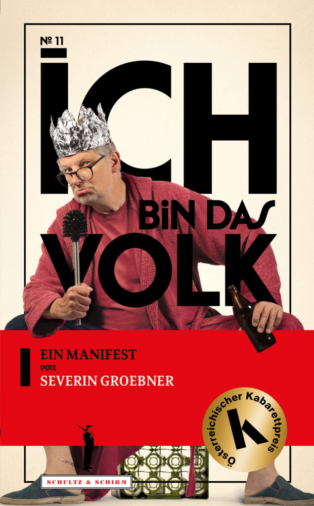 Cover von "Ich bin das Volk", Severin Groebner im roten Bademantel, eine Klobürste als Mikrofon, eine Alukrone auf dem Kopf